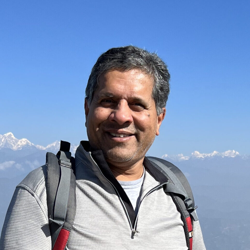 Image of George in front of the Himalayas